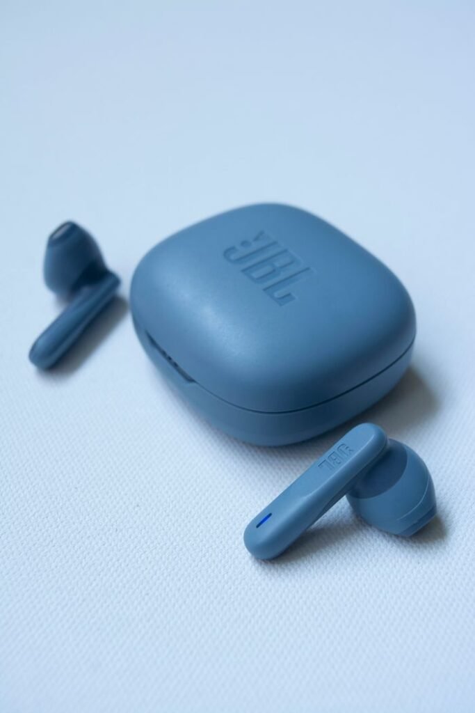 Blue wireless earbuds and case showcasing modern technology on a clean white background.