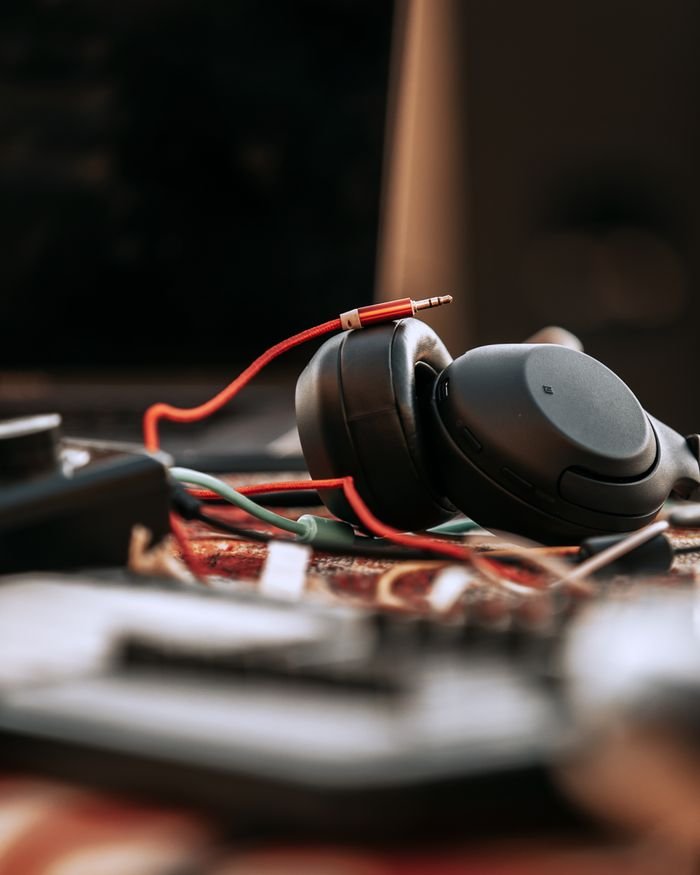 Close-up view of black headphones with cables on a table in Baku, showcasing electronics and technology.